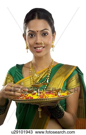 Portrait of a woman holding a tray with diyas View Large Photo Image Stock Image - Portrait of a woman holding a tray with diyas . Fotosearch