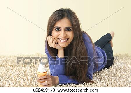 Portrait of a woman holding an ice cream cone View Large Photo Image Stock Image - Portrait of a woman holding an ice cream cone . Fotosearch