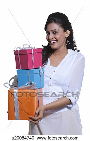 Portrait of a woman holding gift boxes View Large Photo Image Stock Image - Portrait of a woman holding gift boxes. Fotosearch
