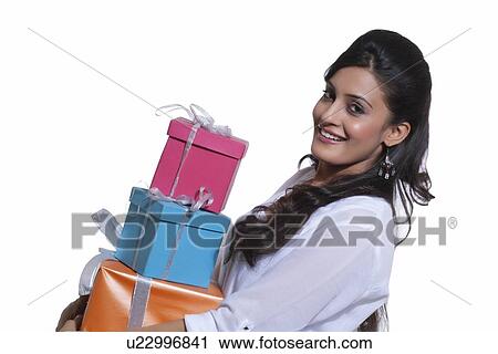 Portrait of a woman holding gift boxes View Large Photo Image Stock Image - Portrait of a woman holding gift boxes. Fotosearch