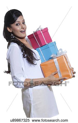 Stock Photography - Portrait of a woman holding gift boxes. Fotosearch