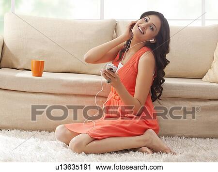 Portrait of a woman listening to music View Large Photo Image Stock Image - Portrait of a woman listening to music. Fotosearch