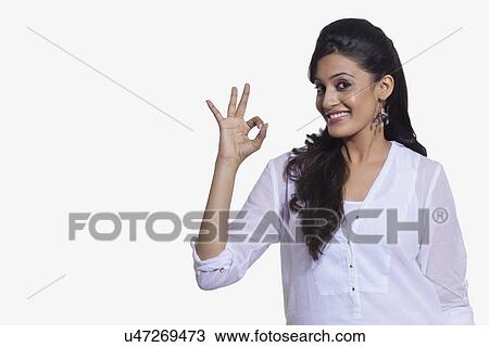 Stock Image - Portrait of a woman making ok sign. Fotosearch
