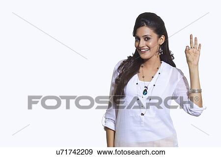 Stock Photo - Portrait of a woman making ok sign. Fotosearch