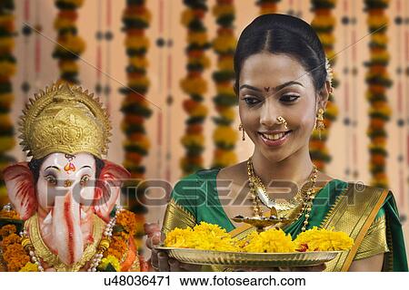 Portrait of a woman performing a pooja View Large Photo Image Stock Image - Portrait of a woman performing a pooja . Fotosearch