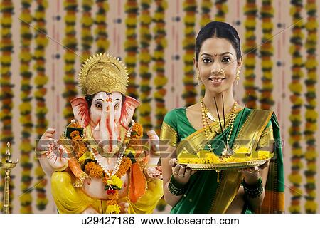 Portrait of a woman performing a pooja View Large Photo Image Stock Photograph - Portrait of a woman performing a pooja . Fotosearch