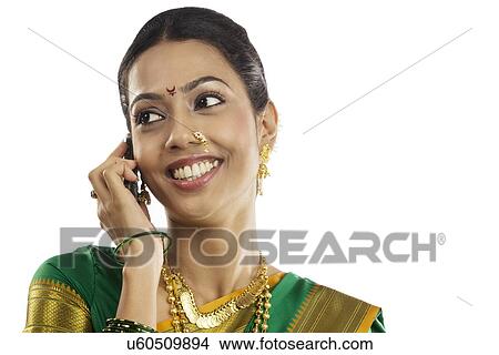Portrait of a woman talking on a mobile phone View Large Photo Image Picture - Portrait of a woman talking on a mobile phone . Fotosearch