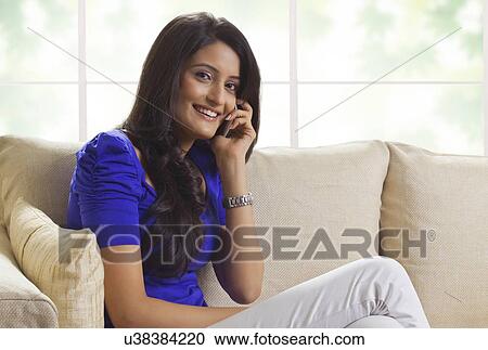 Portrait of a woman talking on a mobile phone View Large Photo Image Stock Image - Portrait of a woman talking on a mobile phone. Fotosearch
