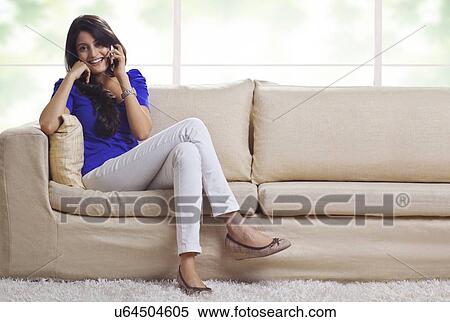 Stock Photography - Portrait of a woman talking on a mobile phone. Fotosearch