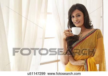 Stock Photo - Portrait of a woman with a cup of coffee. Fotosearch
