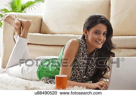 Stock Image - Portrait of a woman with a laptop. Fotosearch