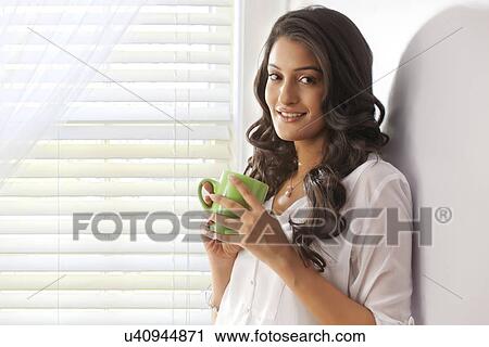 Portrait of a woman with a mug of tea View Large Photo Image Stock Image - Portrait of a woman with a mug of tea. Fotosearch