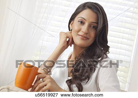 Stock Photo - Portrait of a woman with a mug of tea. Fotosearch