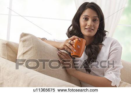 Stock Photography - Portrait of a woman with a mug of tea. Fotosearch