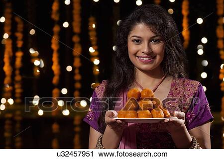 Portrait of a woman with a plate of sweets View Large Photo Image Stock Image - Portrait of a woman with a plate of sweets. Fotosearch