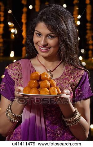 Portrait of a woman with a plate of sweets View Large Photo Image Stock Photo - Portrait of a woman with a plate of sweets. Fotosearch