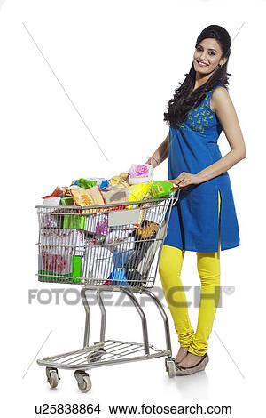 Picture - Portrait of a woman with a shopping cart. Fotosearch