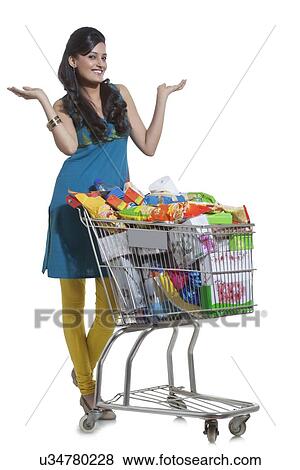 Stock Photo - Portrait of a woman with a shopping cart. Fotosearch