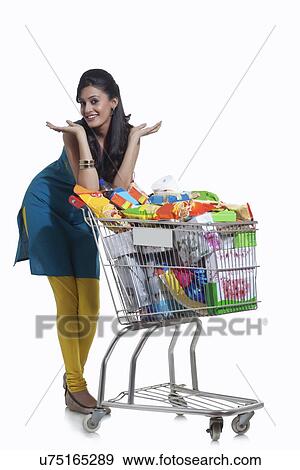 Stock Photo - Portrait of a woman with a shopping cart. Fotosearch