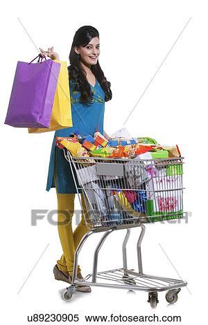 Portrait of a woman with a shopping cart and shopping bags View Large Photo Image Stock Photography - Portrait of a woman with a shopping cart and shopping bags. Fotosearch