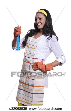 Stock Photo - Portrait of a woman with cleaning liquid. Fotosearch