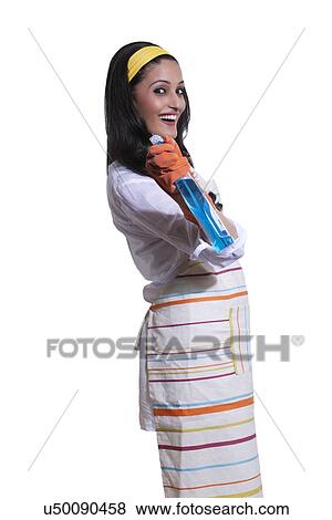 Stock Photo - Portrait of a woman with cleaning liquid. Fotosearch