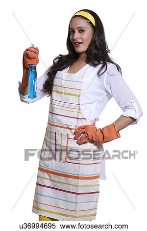 Stock Photography - Portrait of a woman with cleaning liquid. Fotosearch