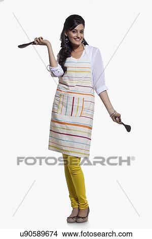 Picture - Portrait of a woman with cooking utensils. Fotosearch