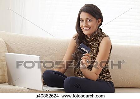 Picture - Portrait of a woman with credit card. Fotosearch