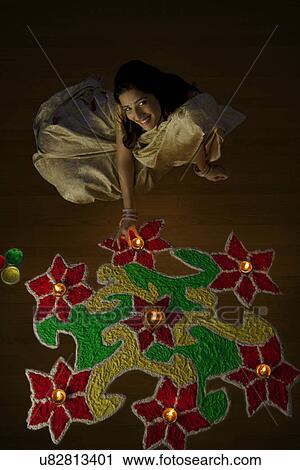 Stock Image - Portrait of a woman with diyas . Fotosearch