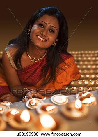 Stock Photo - Portrait of a woman with diyas . Fotosearch