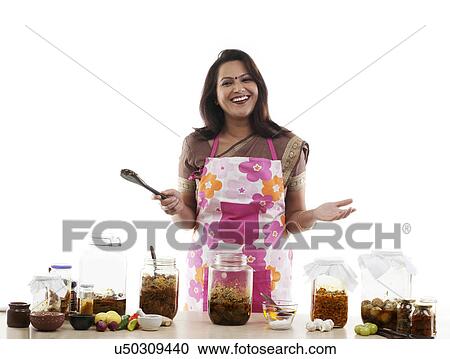 Stock Image - Portrait of a woman with pickle jars . Fotosearch