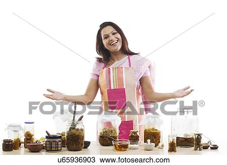 Stock Image - Portrait of a woman with pickle jars . Fotosearch