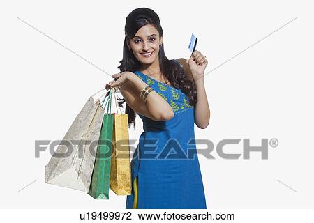 Stock Image - Portrait of a woman with shopping bags and credit card. Fotosearch