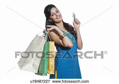 Stock Photo - Portrait of a woman with shopping bags and credit card. Fotosearch
