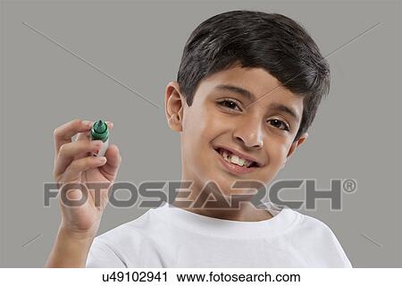 Portrait of a young boy holding a marker pen View Large Photo Image Stock Image - Portrait of a young boy holding a marker pen . Fotosearch