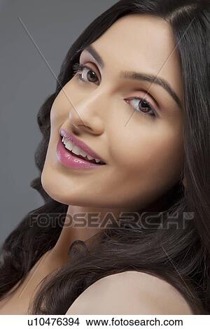 Picture - Portrait of a young female smiling over colored background . Fotosearch