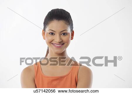 Portrait of a young fitness woman smiling over white background View Large Photo Image Stock Photograph - Portrait of a young fitness woman smiling over white background . Fotosearch
