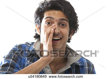 Stock Photo - Portrait of a young man cheering . Fotosearch