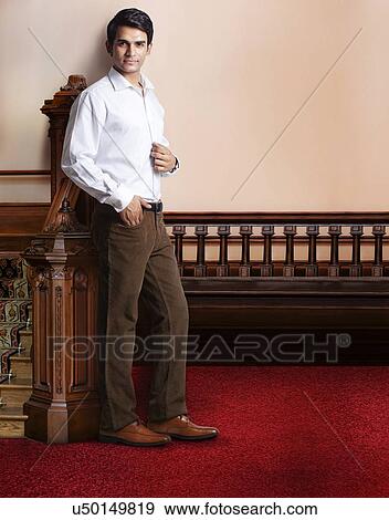 Portrait of a young man standing beside staircase View Large Photo Image Stock Photo - Portrait of a young man standing beside staircase . Fotosearch