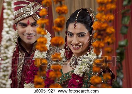 Stock Photo - Portrait of an attractive newlywed couple smiling . Fotosearch