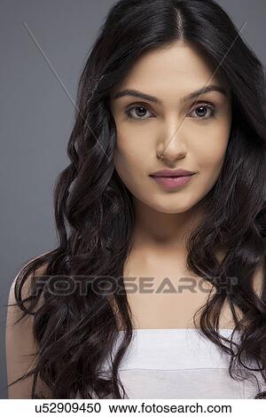 Portrait of an attractive young female with long hair over colored background View Large Photo Image Stock Image - Portrait of an attractive young female with long hair over colored background . Fotosearch