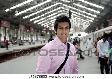 Stock Image - Portrait of an businessman at a train station . Fotosearch