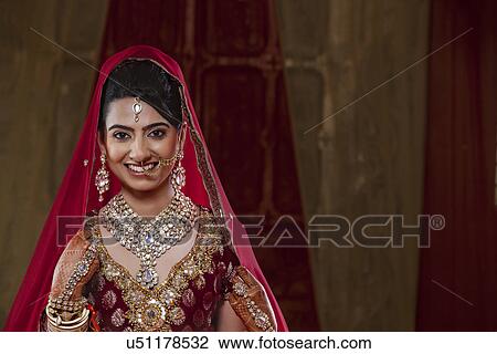 Portrait of an Indian bride in traditional clothing and jewelry View Large Photo Image Stock Image - Portrait of an Indian bride in traditional clothing and jewelry . Fotosearch