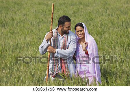 Portrait of an Indian woman standing with her husband in wheat field View Large Photo Image Stock Image - Portrait of an Indian woman standing with her husband in wheat field . Fotosearch