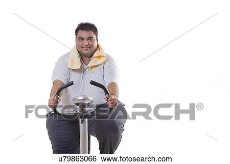 Stock Photograph - Portrait of an obese man exercising over white background . Fotosearch
