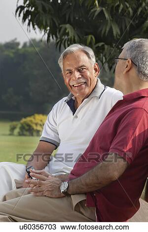 Stock Image - Portrait of an old man in a park . Fotosearch