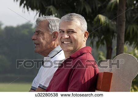 Stock Photo - Portrait of an old man in a park . Fotosearch