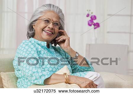 Portrait of an old woman talking on mobile phone View Large Photo Image Stock Photography - Portrait of an old woman talking on mobile phone. Fotosearch