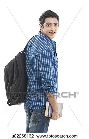 Portrait of aspiring young man with book and bag over white background View Large Photo Image Stock Image - Portrait of aspiring young man with book and bag over white background . Fotosearch